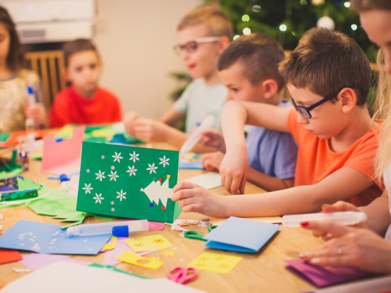 A Group of children work on their holiday crafts at a table